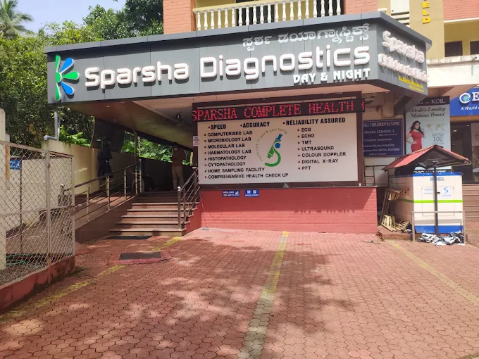Entrance of the Sparsha Diagnostics main branch at Upper Bendoor, Kankanady, with the day and night signboard