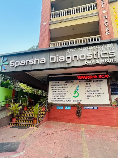 Sparsha Diagnostics entrance with the day and night signboard, at Upper Bendoor